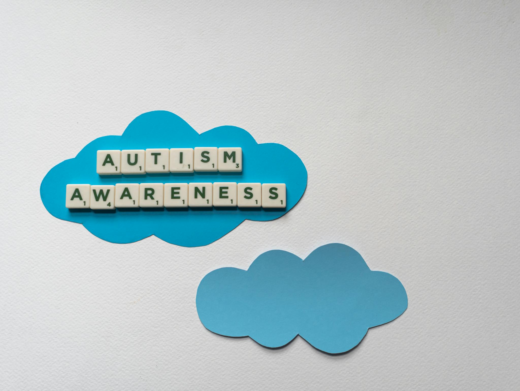 White Letter Tiles Spelling Autism Awareness On